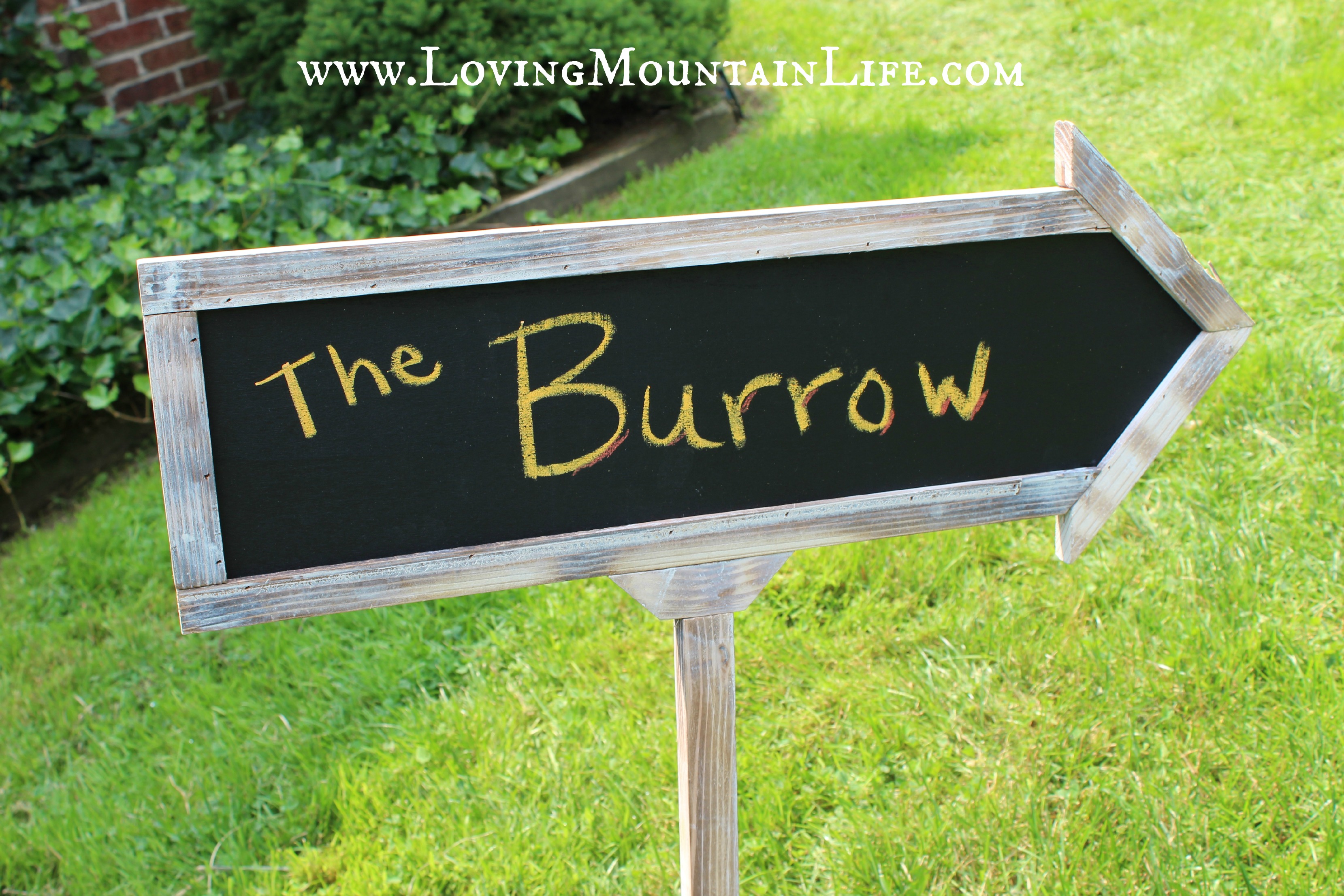 Rustic sign directing guests to The Burrow